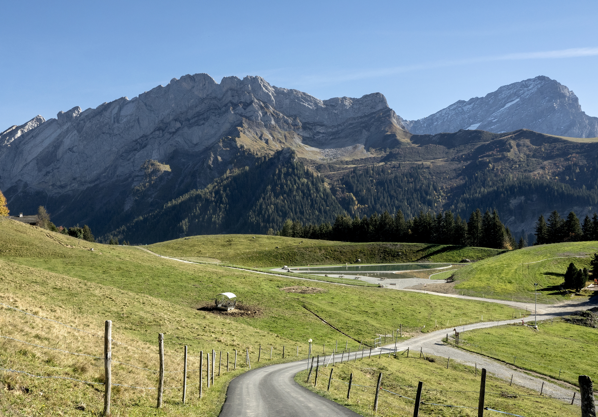 A swimming lake nestled in alpine pastures