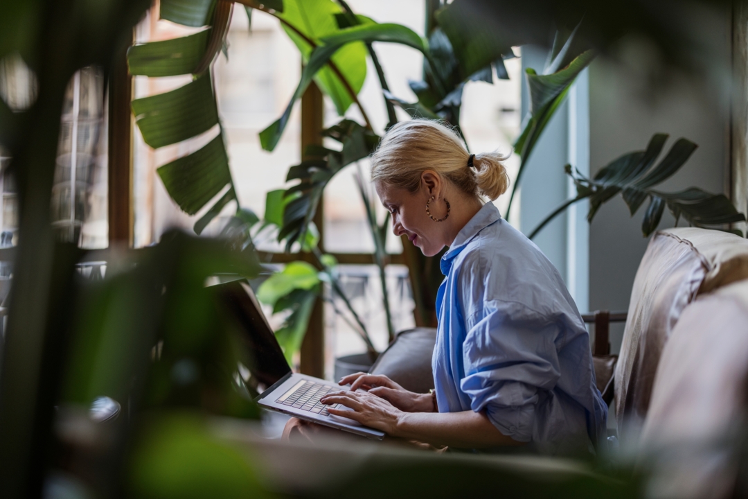 Beautiful stylish independent Caucasian woman working freelance in a modern cafe.