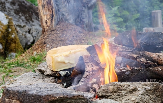 Raclette prepared on a wood fire